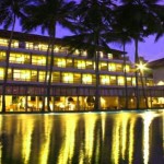 Blue water resorts at night over the pool